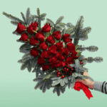 Christmas Hand Bouquet – Elegant festive bouquet featuring fresh seasonal flowers with holiday-inspired wrapping, perfect for Christmas gifting, celebrations, and winter décor.