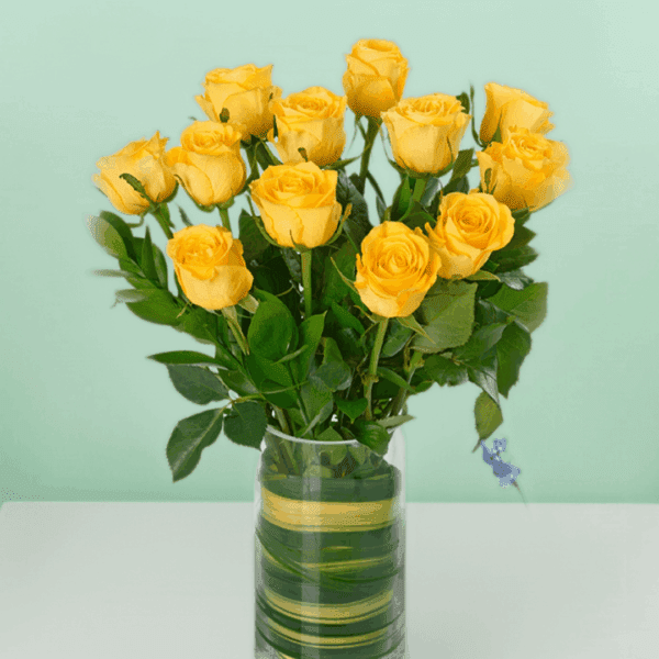Classic dozen yellow rose bouquet wrapped elegantly with fresh green fillers and ribbon, perfect for birthday celebrations, anniversaries, and cheerful gifting moments.