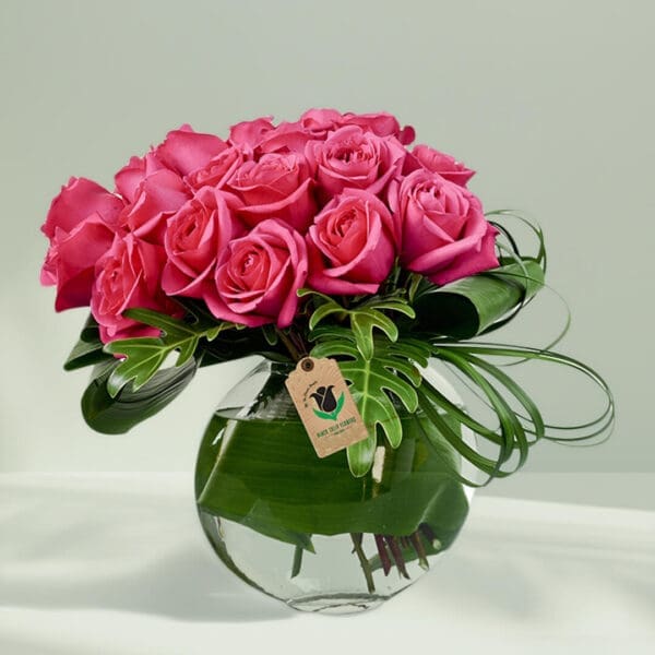 20 to 25 Pink rose in Glass vase with foilage
