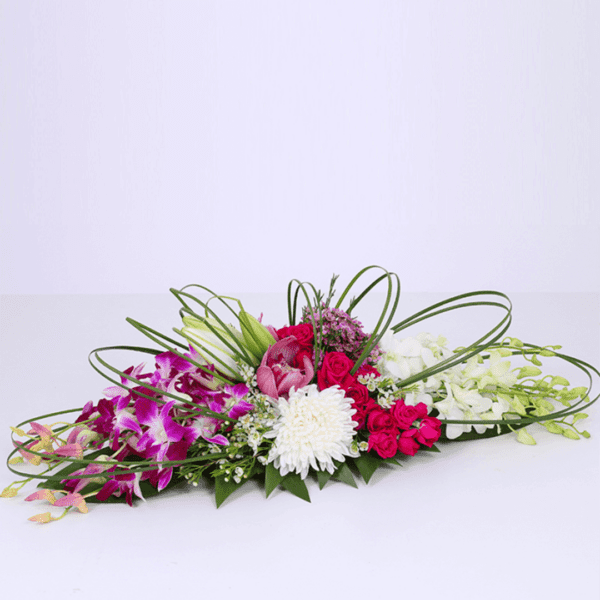 long and low arrangement purple, white and fuschia theme