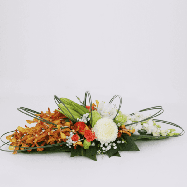 Long and low arrangement - Orange Theme | Blacktulipflowers.in