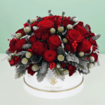 Elegant holiday flower arrangement in a decorative gift box featuring fresh seasonal blooms, perfect for festive celebrations, gifting, and special occasions.