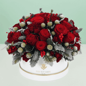 Elegant holiday flower arrangement in a decorative gift box featuring fresh seasonal blooms, perfect for festive celebrations, gifting, and special occasions.