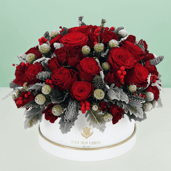 Elegant holiday flower arrangement in a decorative gift box featuring fresh seasonal blooms, perfect for festive celebrations, gifting, and special occasions.