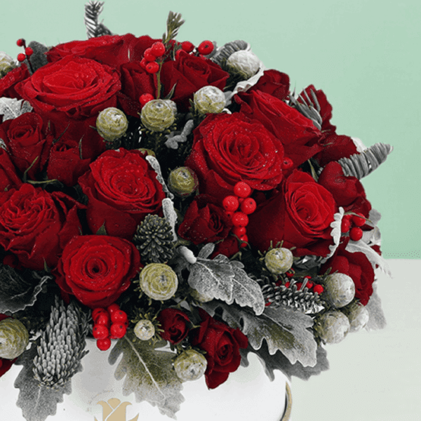 Elegant holiday flower arrangement in a decorative gift box featuring fresh seasonal blooms, perfect for festive celebrations, gifting, and special occasions.