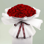 Heartfelt bouquet of red roses tied with a satin ribbon.