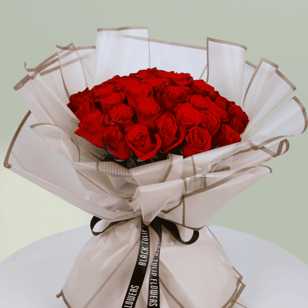 A bouquet of vibrant red roses wrapped beautifully for Valentine's Day. Order red rose bouquet