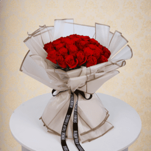 A bouquet of vibrant red roses wrapped beautifully for Valentine's Day. Order red rose bouquet