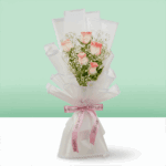 Bouquet of blush pink roses wrapped in white Korean style sheet