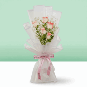 Bouquet of blush pink roses wrapped in white Korean style sheet