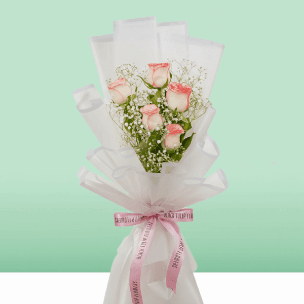 Blush Glow Bouquet (4) Bouquet of blush pink roses wrapped in white Korean style sheet