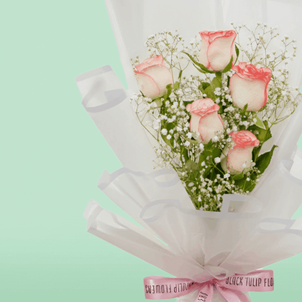 Blush Glow Bouquet (5) Bouquet of blush pink roses wrapped in white Korean style sheet