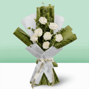 A Bouquet of 7 white roses wrapped in green and white paper.