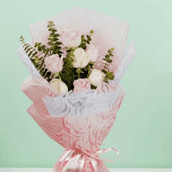 A lovely Bouquet of Elegant 7-pink And Peach rose bouquet wrapped in pink paper.