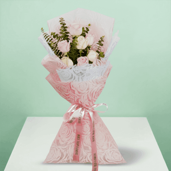 A lovely Bouquet of Elegant 7-pink And Peach rose bouquet wrapped in pink paper.