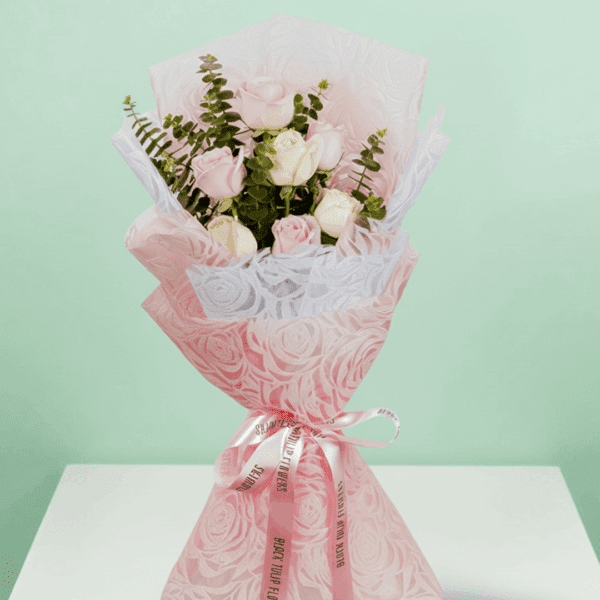 A lovely Bouquet of Elegant 7-pink And Peach rose bouquet wrapped in pink paper.