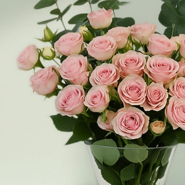 A bunch of romantic rose and eucalyptus in a glass vase