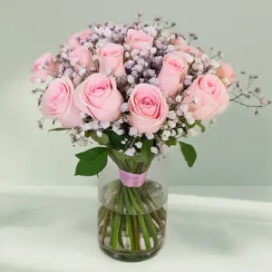 A bunch of elegant pink roses arranged in a transparent glass vase