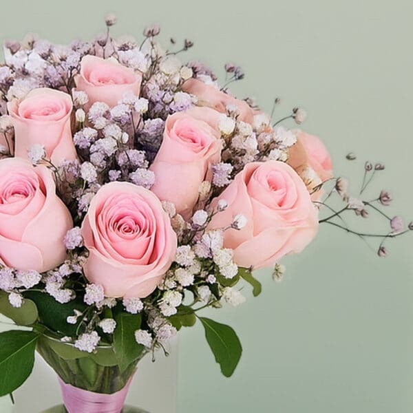 A bunch of elegant pink roses arranged in a transparent glass vase