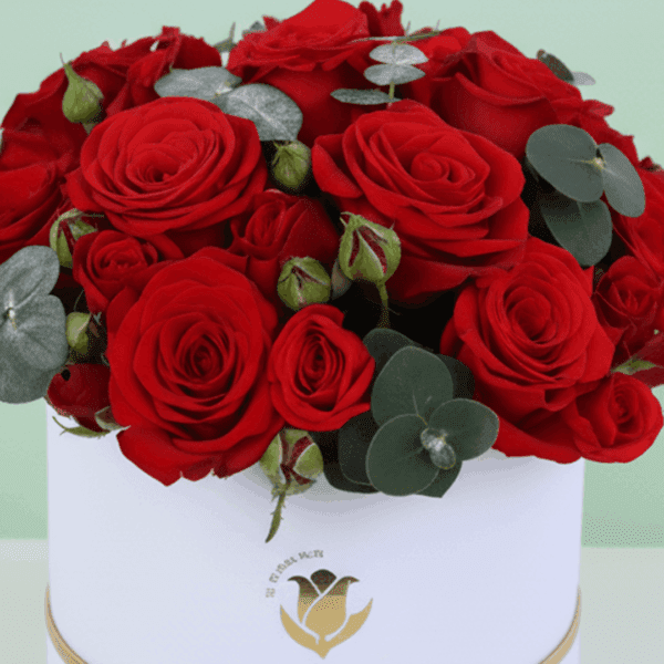 Valentine’s Day red roses with eucalyptus arranged in a luxury white flower box.
