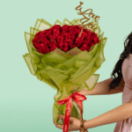 Valentine’s bouquet of 50 red roses wrapped in Korean-style flower sheets with an 'I Love You' topper