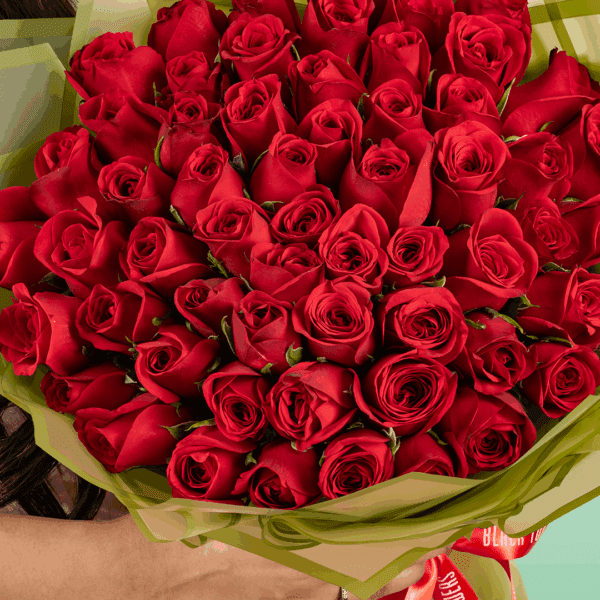 Valentine’s bouquet of 50 red roses wrapped in Korean-style flower sheets with an 'I Love You' topper