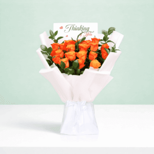 Hand-tied orange rose flower bouquet styled with white wrapping and printed message card saying 'thinking of you'