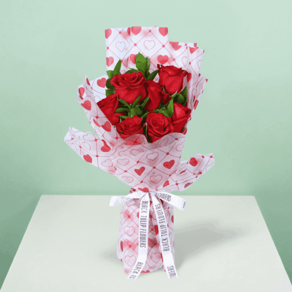 blush-of-love-rose-bouquet (2) Romantic red rose bouquet with fresh green leaves, wrapped in elegant Korean-style flower sheets