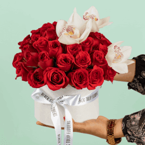 50 red and white roses with Cymbidium arranged in a white round box and tied with a whte satin ribbon