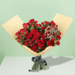A luxurious arrangement of vibrant red roses, beautifully gathered and wrapped in non-woven paper.
