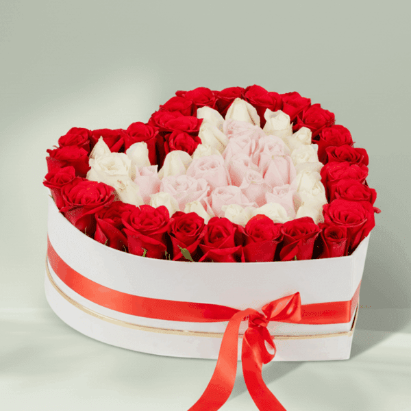 White heart-shaped box with 50–55 assorted roses and a Valentine topper