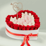 White heart-shaped box with 50–55 assorted roses and a Valentine topper