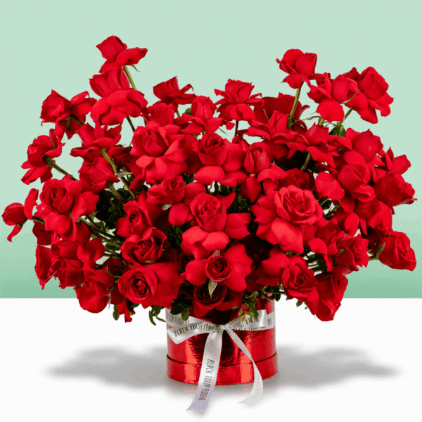 Valentine-themed flower box featuring red roses arranged in a luxurious circular design