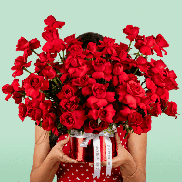 Valentine-themed flower box featuring red roses arranged in a luxurious circular design