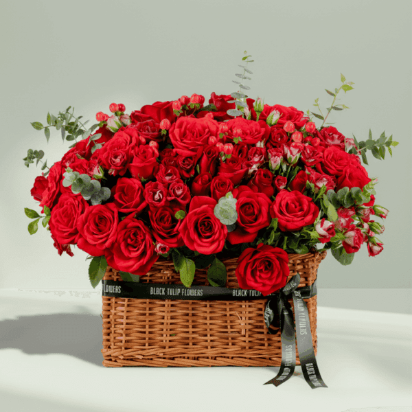 grandeur-mixed-flowers-rectangle-basket (1) Rectangle basket arrangement of red roses, spray roses, hypericum, and eucalyptus with a Valentine’s topper