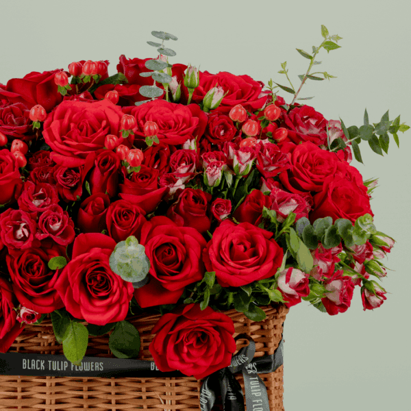 grandeur-mixed-flowers-rectangle-basket (2) Rectangle basket arrangement of red roses, spray roses, hypericum, and eucalyptus with a Valentine’s topper