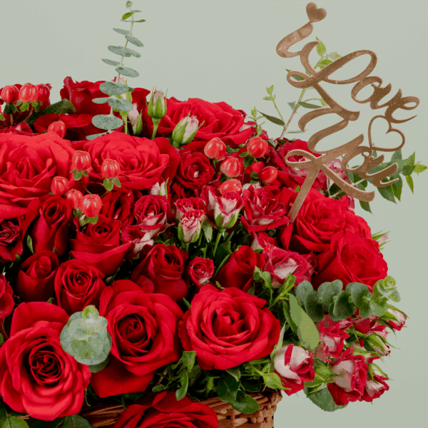grandeur-mixed-flowers-rectangle-basket (4) Rectangle basket arrangement of red roses, spray roses, hypericum, and eucalyptus with a Valentine’s topper