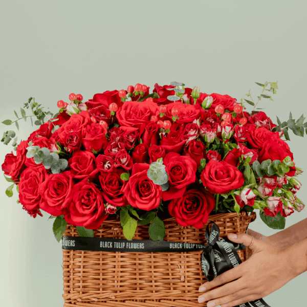 grandeur-mixed-flowers-rectangle-basket (5) Rectangle basket arrangement of red roses, spray roses, hypericum, and eucalyptus with a Valentine’s topper