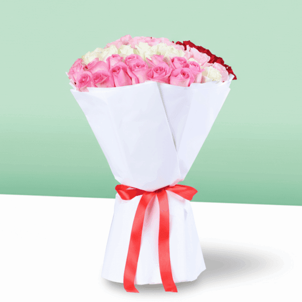 Bouquet of red, pink, and white roses in a premium white wrap, finished with a ribbon.