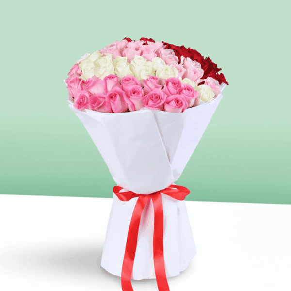 Bouquet of red, pink, and white roses in a premium white wrap, finished with a ribbon.