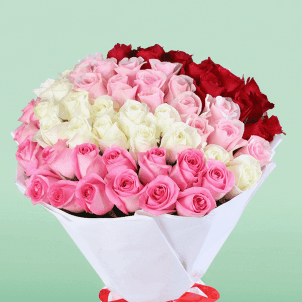 Bouquet of red, pink, and white roses in a premium white wrap, finished with a ribbon.