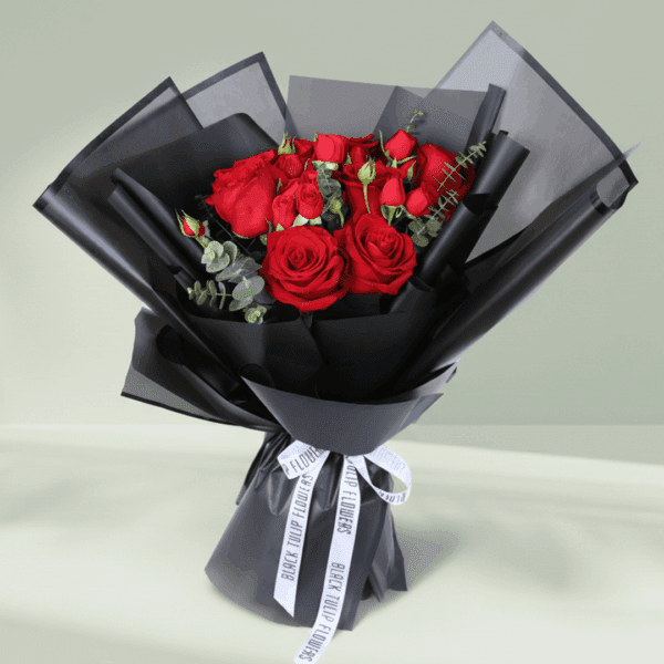 "Red roses with delicate spray roses and eucalyptus, wrapped in elegant black Korean-style flower sheets"