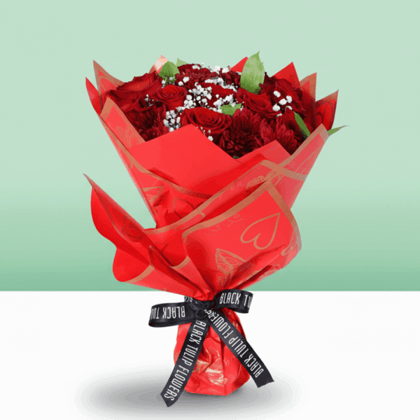 "Romantic red floral arrangement with roses, chrysanthemums, green leaves, and a golden “Love You” topper in Korean wrapping. "