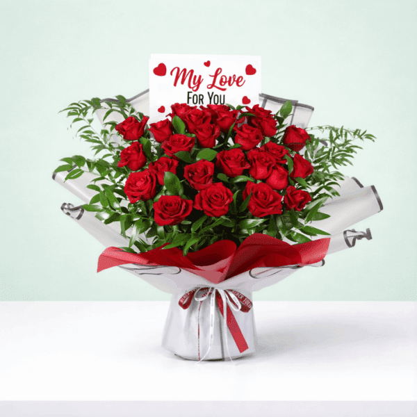 Romantic floral arrangement in rich red tones with fresh greenery, paired with a beautiful red ribbon and a heartfelt “I’m sorry” note.