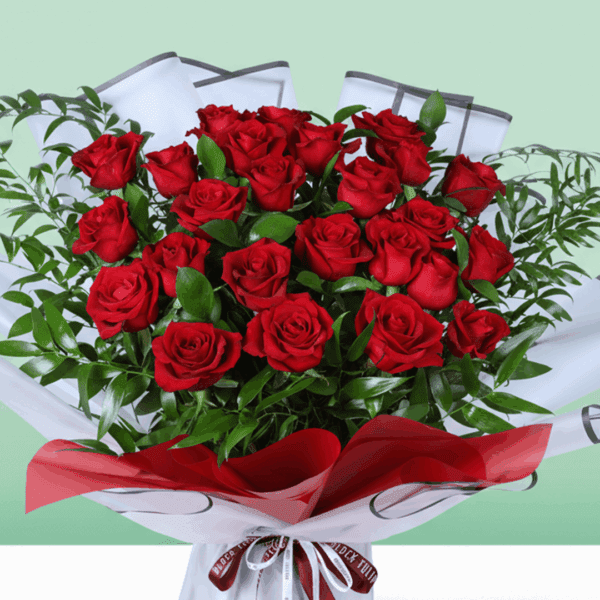 Romantic floral arrangement in rich red tones with fresh greenery, paired with a beautiful red ribbon and a heartfelt “I’m sorry” note.
