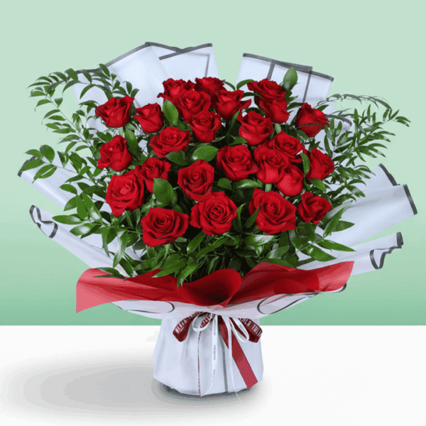 Romantic floral arrangement in rich red tones with fresh greenery, paired with a beautiful red ribbon and a heartfelt “I’m sorry” note.