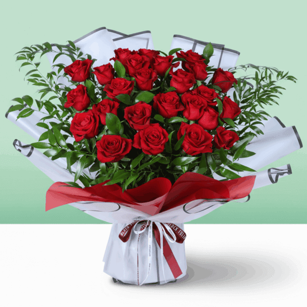 Romantic floral arrangement in rich red tones with fresh greenery, paired with a beautiful red ribbon and a heartfelt “I’m sorry” note.