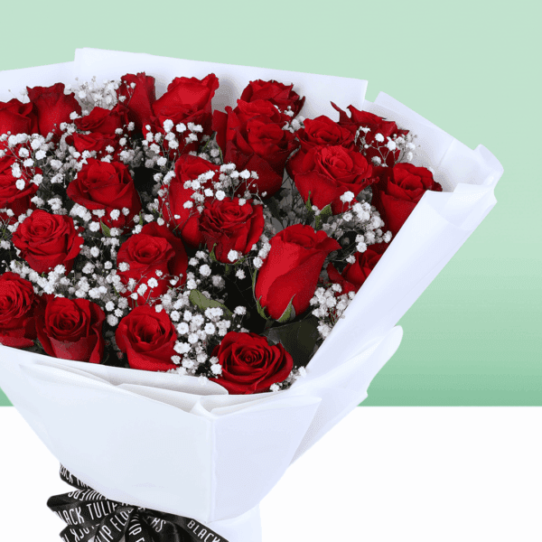 Red roses bouquet with baby’s breath wrapped in white and tied with a black ribbon.