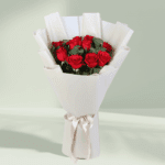 Bouquet of red roses and green foliage in a crisp white wrap with a satin ribbon.