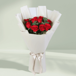 Bouquet of red roses and green foliage in a crisp white wrap with a satin ribbon.